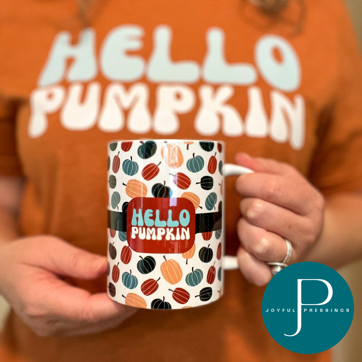 person holding hello pumpkin mug