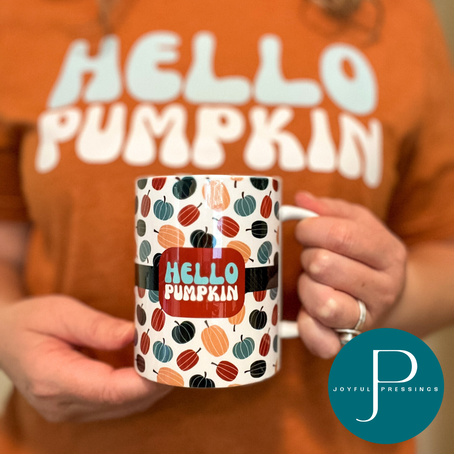 person holding hello pumpkin mug