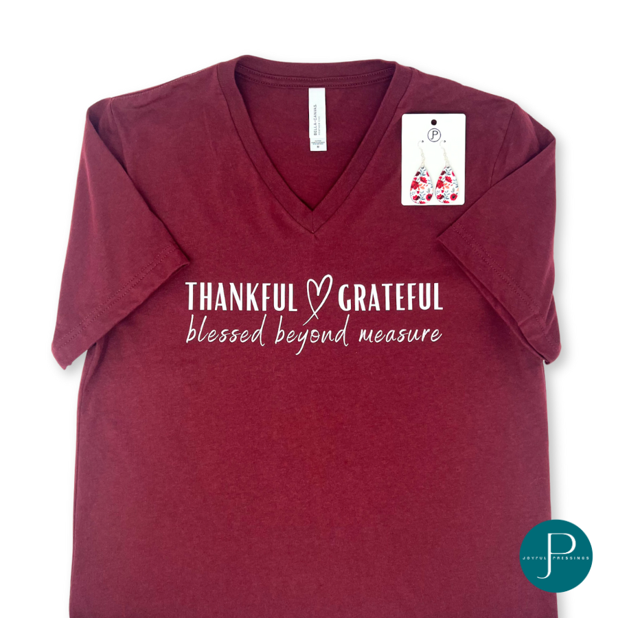 Flatlay of Thankful Grateful tee paired with the red floral teardrop earrings.