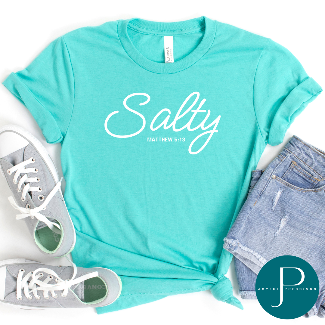 Salty Matthew 5:13 white print on a sea green crew neck tee.