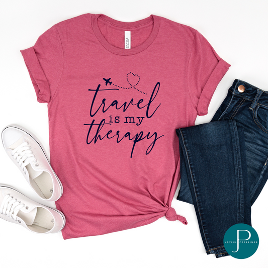 flatlay mockup of travel is my therapy print on a raspberry colored tee