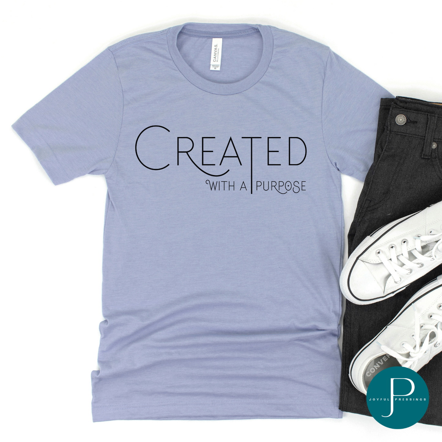 Flatlay picture of the Created with a Purpose graphic on a heather blue tee.