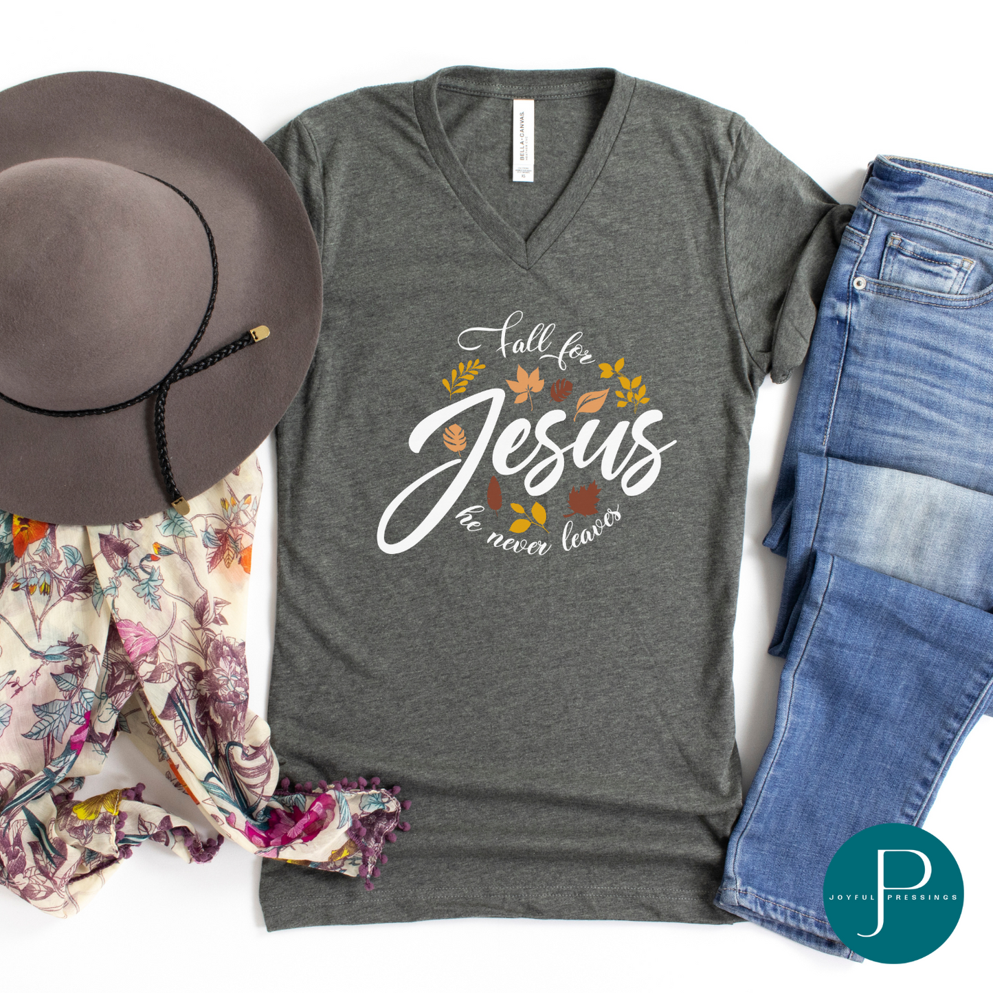 Flat-lay of grey v-neck shirt with the print Fall for Jesus he never leaves.  