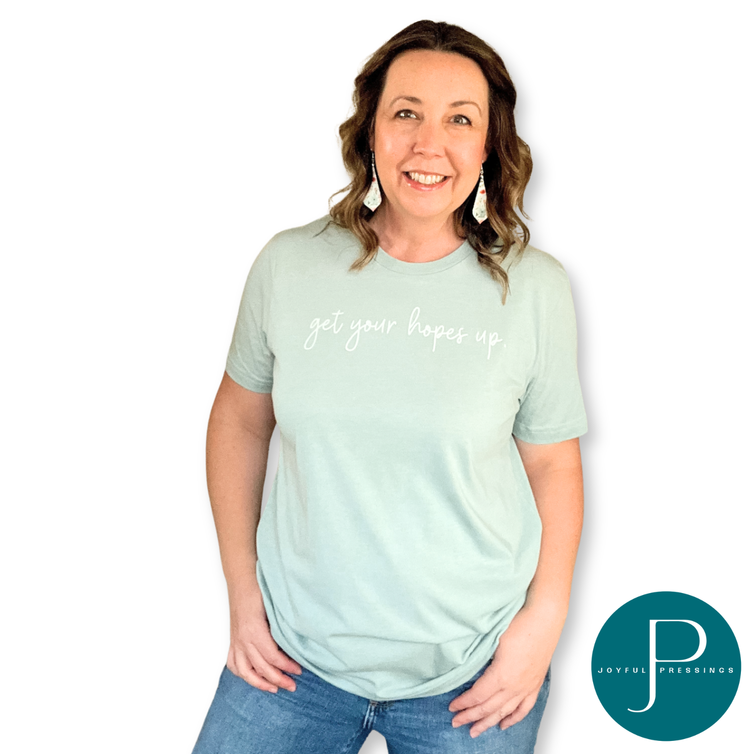 Model wearing Get your hopes up white print on the front of a light sage green tee.