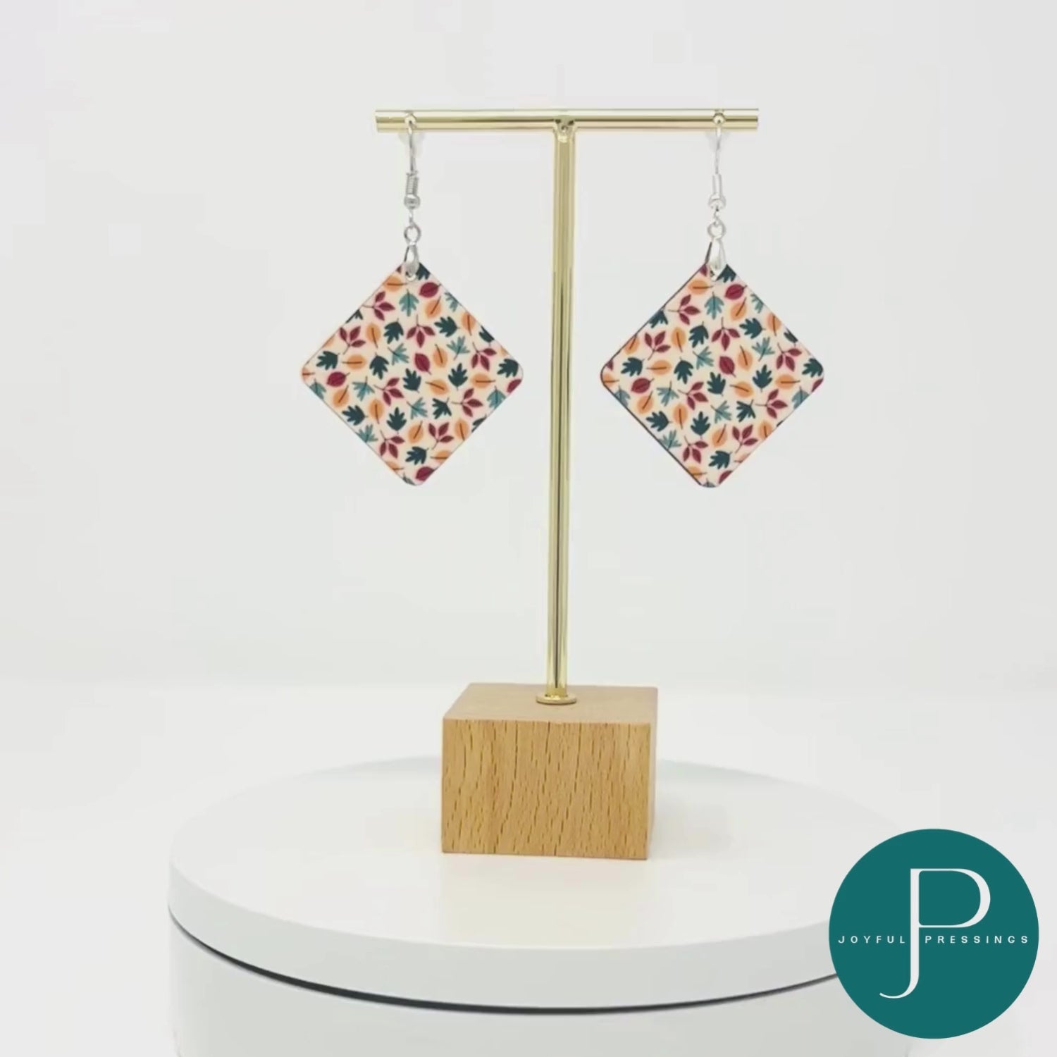 Video showcasing Fall Leaves earrings on turntable.