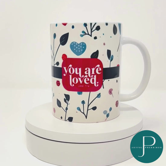 rotating video of the you are loved floral mug