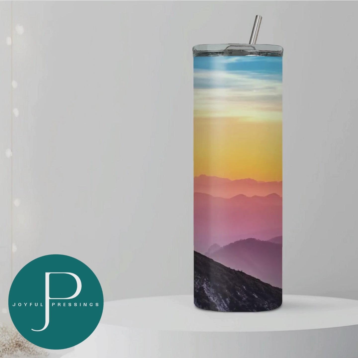 Video of Faith Can Move Mountains tumbler with a sunset in the background.