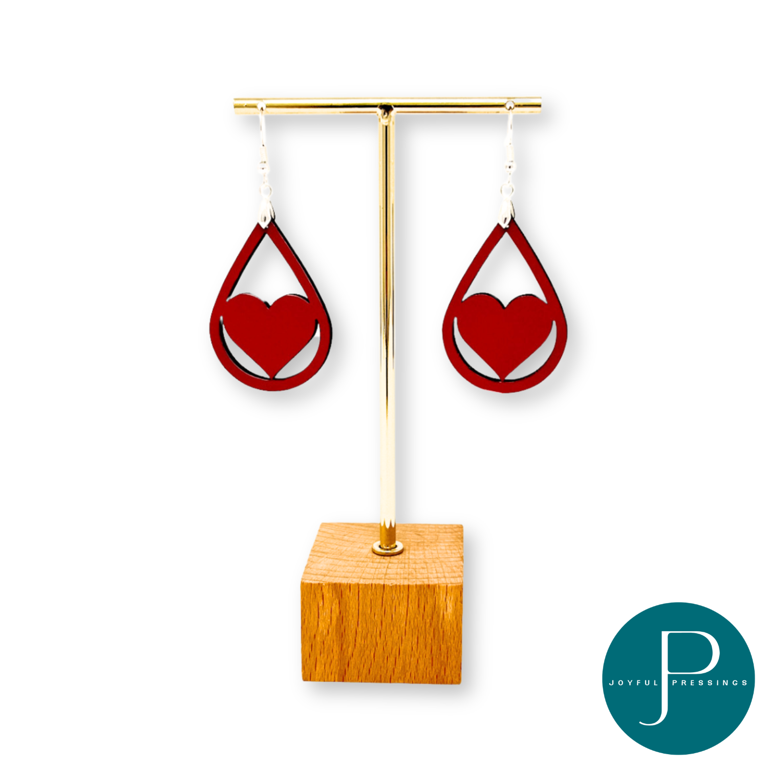 red heart teardrop earrings displayed on a stand