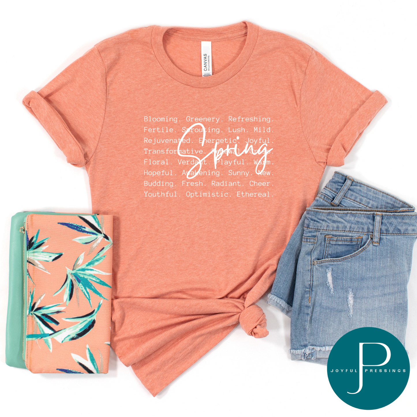 flatlay of a spring white print on a soft heather sunset t-shirt