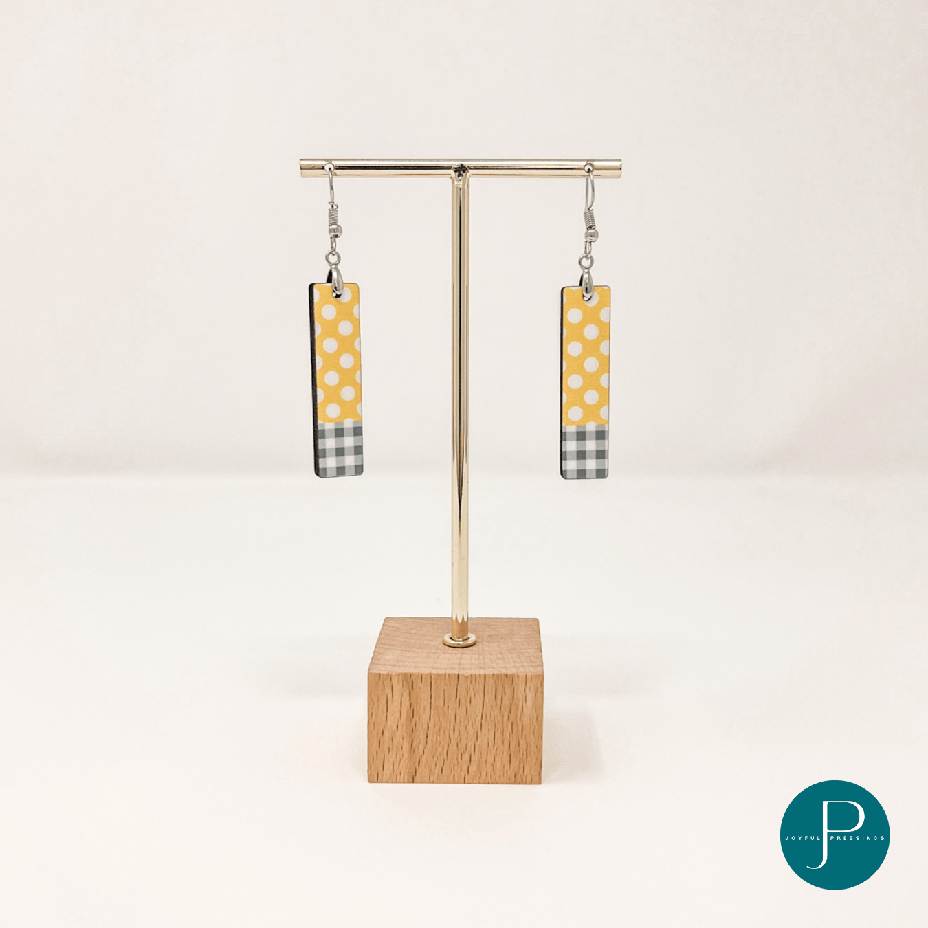 display showcasing yellow and white polka dot earrings with grey plaid.