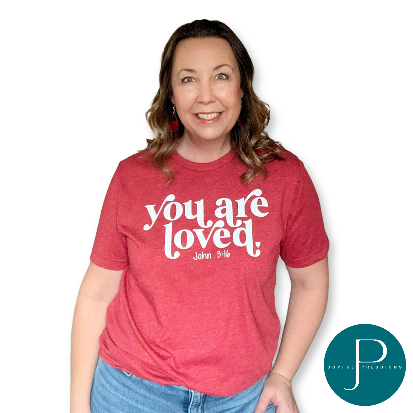 model wearing a canvas red tee with you are loved in white