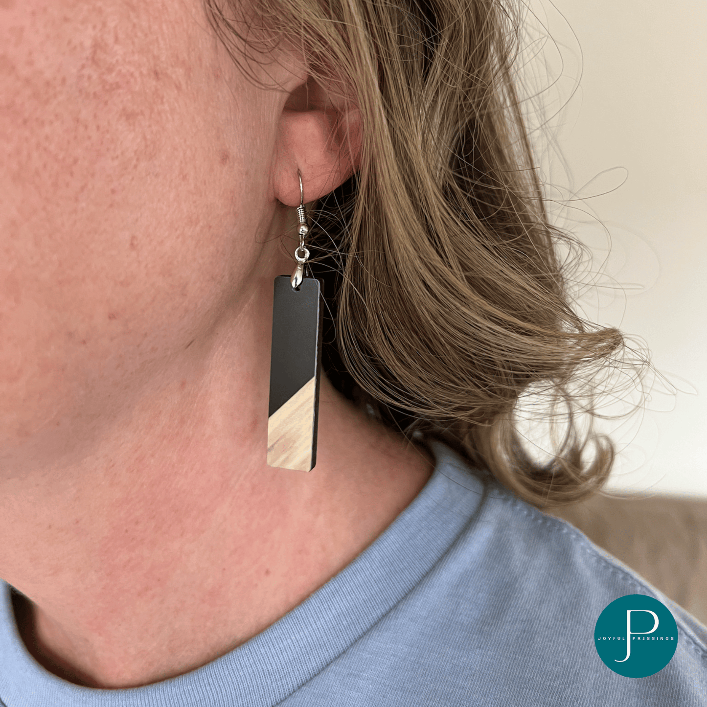 model wearing black and wood bar earrings